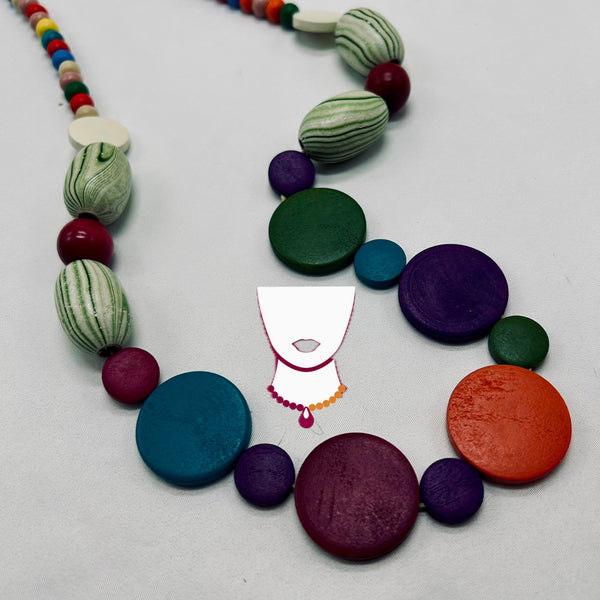 Colorful necklace with round and striped beads on a light gray background