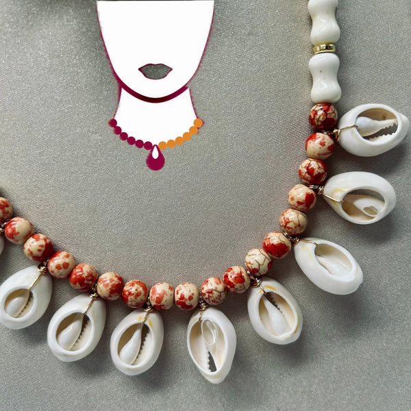 Necklace with shell and bead design on a gray background