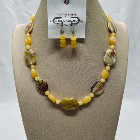 Necklace and earrings set on a mannequin with a visible brand tag.