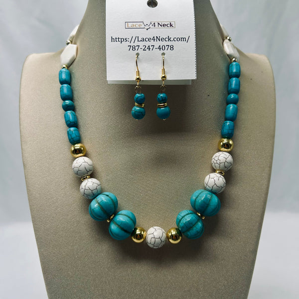 Turquoise and white marbled bead necklace with gold spacer beads, displayed on a neutral jewelry bust alongside matching drop earrings on a white tag.