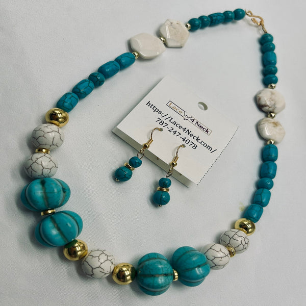 A turquoise and white marbled bead necklace with gold-tone spacer beads, displayed with matching drop earrings on a white card tag. The necklace features large round turquoise beads, smaller turquoise beads, irregular white marbled beads, and polished gold spacer beads, arranged on a light gray background.