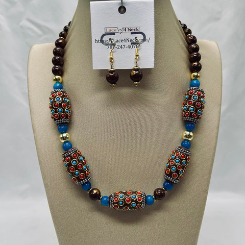 Beaded necklace and earrings set on a mannequin bust with a visible brand tag.
