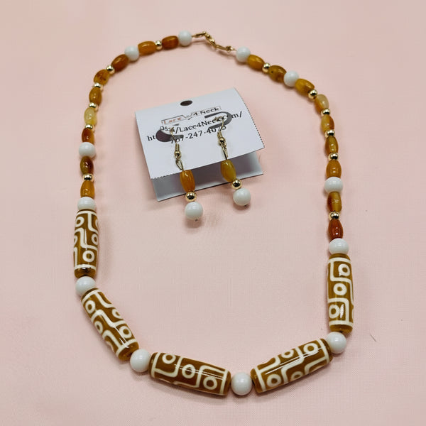 Beaded necklace and earrings with decorative beads on a white background