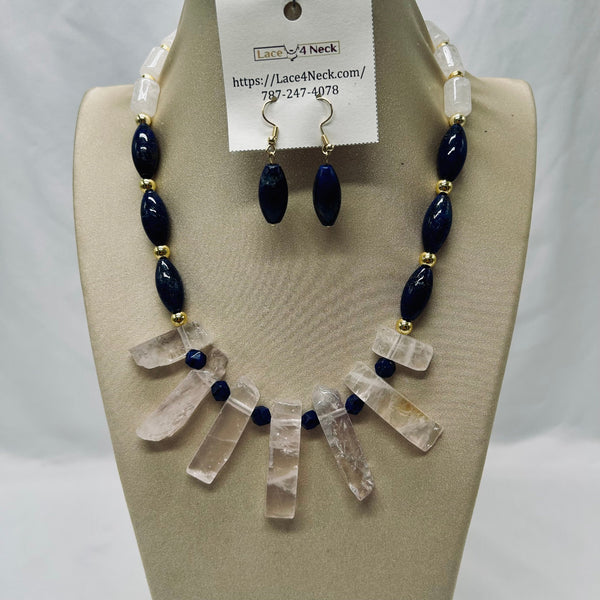 Necklace and earrings set on a mannequin bust with a visible brand tag.