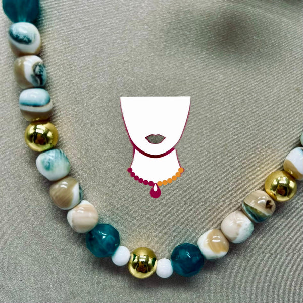 A beaded necklace with marbled white, teal, and brown beads, metallic gold round beads, and small white spacer beads, displayed on a textured gray background. A stylized white female neck graphic with red lips and a beaded necklace overlay is centered.