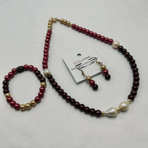 Pearl necklace with maroon, gold, and white beads on a white background