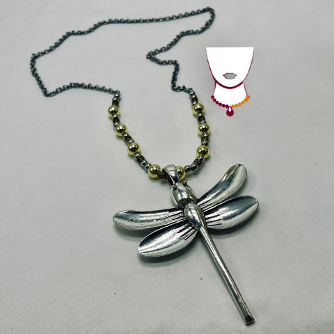 Silver dragonfly pendant on a chain with a gray background