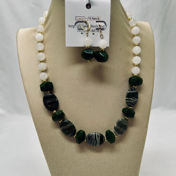 Beaded necklace and earrings set on a mannequin bust with a visible brand tag.
