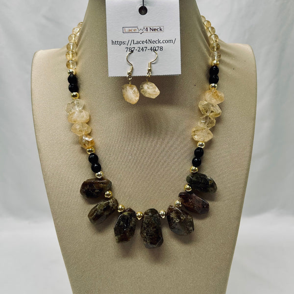 Necklace and earrings set on a mannequin bust with a visible brand tag.