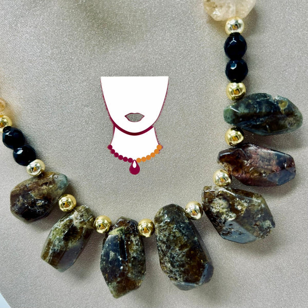 Necklace with natural stone beads and gold accents on a neutral background
