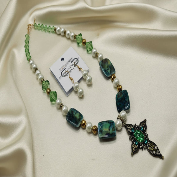 Necklace with green and white beads and a decorative pendant on a white background