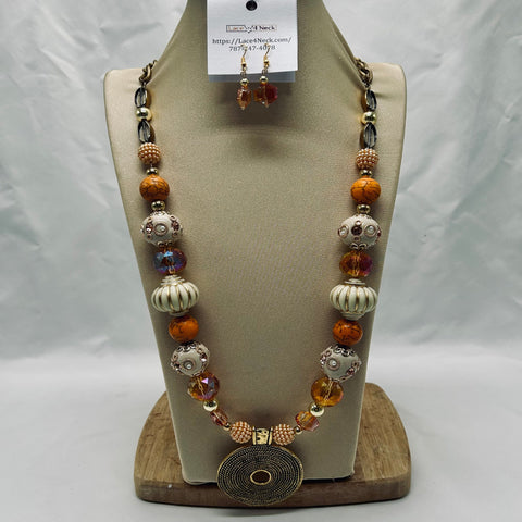 Beaded necklace and earrings on a wooden display stand with a white background