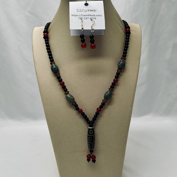 Beaded necklace and earrings on a mannequin bust with a white background