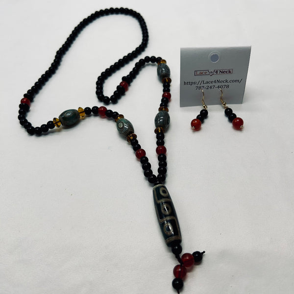 Beaded necklace and earrings on a white background with a business card.