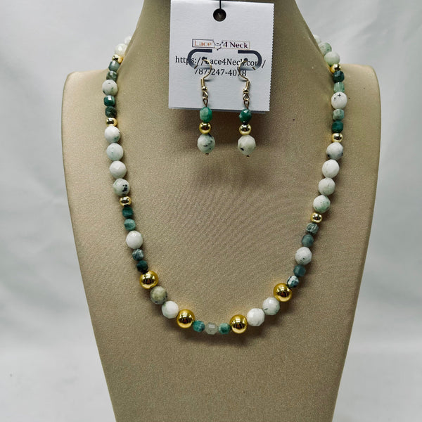 Beaded necklace and earrings set on a mannequin bust with a visible brand tag.