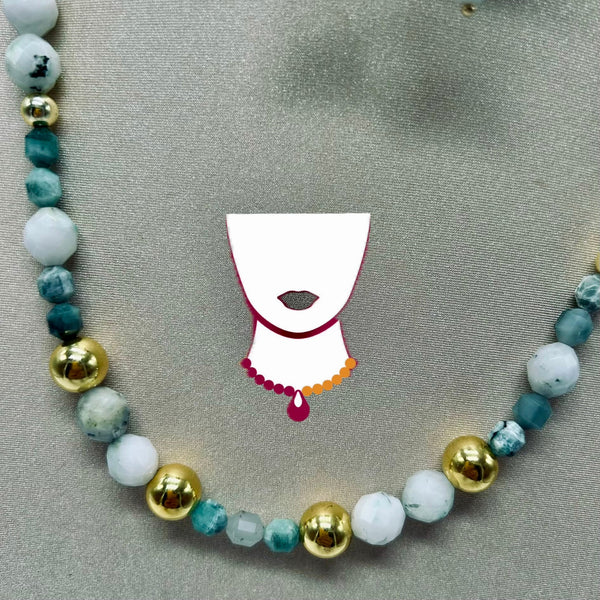 Necklace with multicolored beads and a white pendant on a gray background