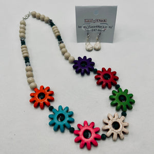 Colorful necklace with flower-shaped beads and matching earrings on a white background.