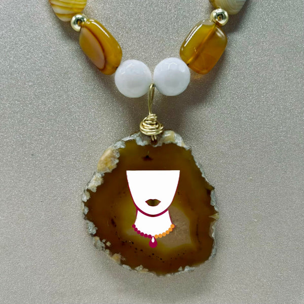 Necklace with a large brown pendant and smaller beads on a neutral background