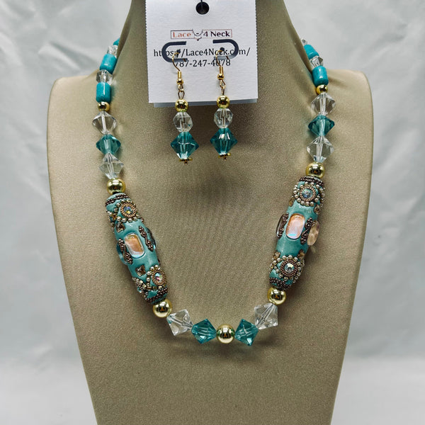 Turquoise and clear beaded necklace and earrings on a display stand with a visible brand tag.