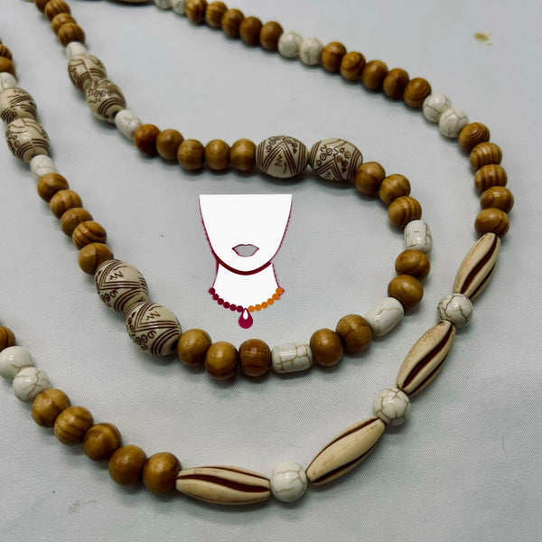 A beaded necklace featuring round medium-brown wooden beads, white marbled beads, and patterned brown-and-white beads, arranged on a light gray background with a decorative neck graphic overlay.